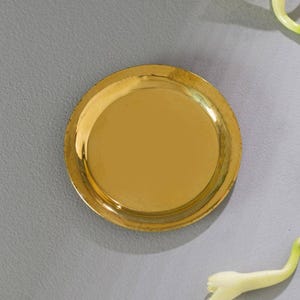 May include: A set of three ceramic mugs with a speckled, cream-colored glaze. Each mug features a different hand-painted floral design in shades of blue, green, and yellow. The mugs have a simple, rounded shape and a comfortable handle.