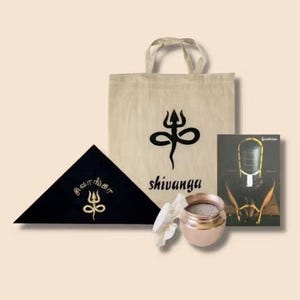 May include: An assortment of items including a beige tote bag with a black symbol and the word "shivanga", a black triangular cloth with gold text, a small copper-colored pot, and a card with an image of a religious figure.