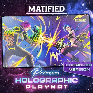 May include: A rectangular playmat featuring a vibrant League of Legends graphic with characters Vi and Jinx in a combat pose. The design includes bright yellow, green, and purple accents against a dark background. Text reads MATIFIED, RIFTBOUND, and ENHANCED VERSION.
