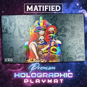 May include: A rectangular playmat featuring a colorful illustration of the One Piece character Monkey D. Luffy wearing a crown and holding a skull, set against a grayscale manga panel background with the text MATIFIED and ONE PIECE visible.