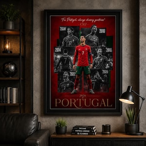 May include: Framed poster featuring Cristiano Ronaldo in a Portugal soccer uniform. The poster has a red background with images of Ronaldo from different years, including 2006, 2010, 2014, 2018, 2022, and 2026. Text includes "For Portugal, always chasing greatness" and "PORTUGAL".