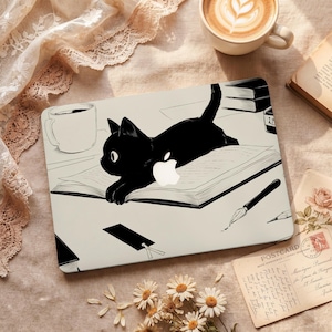 May include: Laptop skin featuring a black cat illustration lying on a book. The design includes a white Apple logo, a coffee cup, and a pen. The background has a vintage aesthetic with a postcard and flowers.