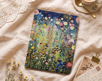 May include: A rectangular notebook featuring a vibrant, colorful illustration of a dense wildflower meadow with various blooms in shades of pink, yellow, blue, and white against a deep blue and green background, showcasing a detailed floral pattern.