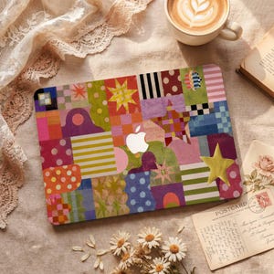May include: A laptop skin featuring a vibrant, multi-colored patchwork design with various geometric shapes, stripes, polka dots, and star motifs in shades of pink, green, blue, orange, and purple, centered with a white Apple logo cutout.