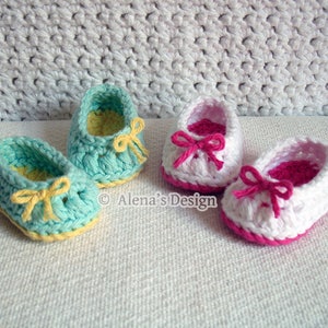 May include: Two pairs of crocheted baby shoes. One pair is light blue with yellow bows and the other pair is white with pink bows.  © Alena's Design