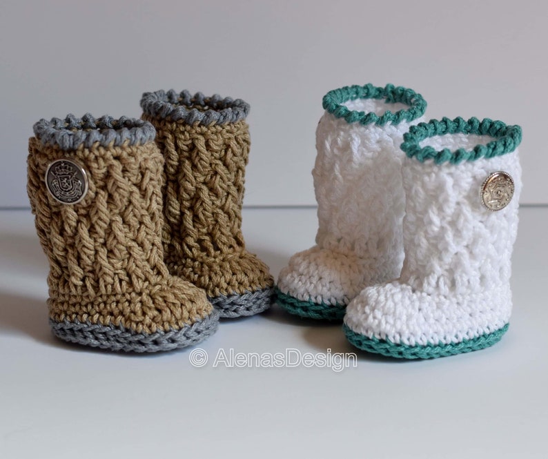May include: Two pairs of crocheted baby booties. One pair is brown with a gray trim and the other pair is white with a teal trim. Both pairs have a button on the side.