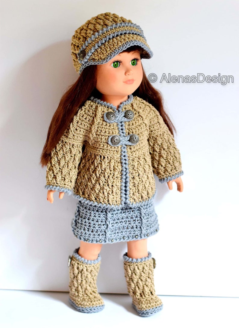 May include: A crocheted outfit for a doll, featuring a brown and blue jacket, skirt, and boots, with a brown and blue hat. The outfit has decorative buttons and a braided trim.