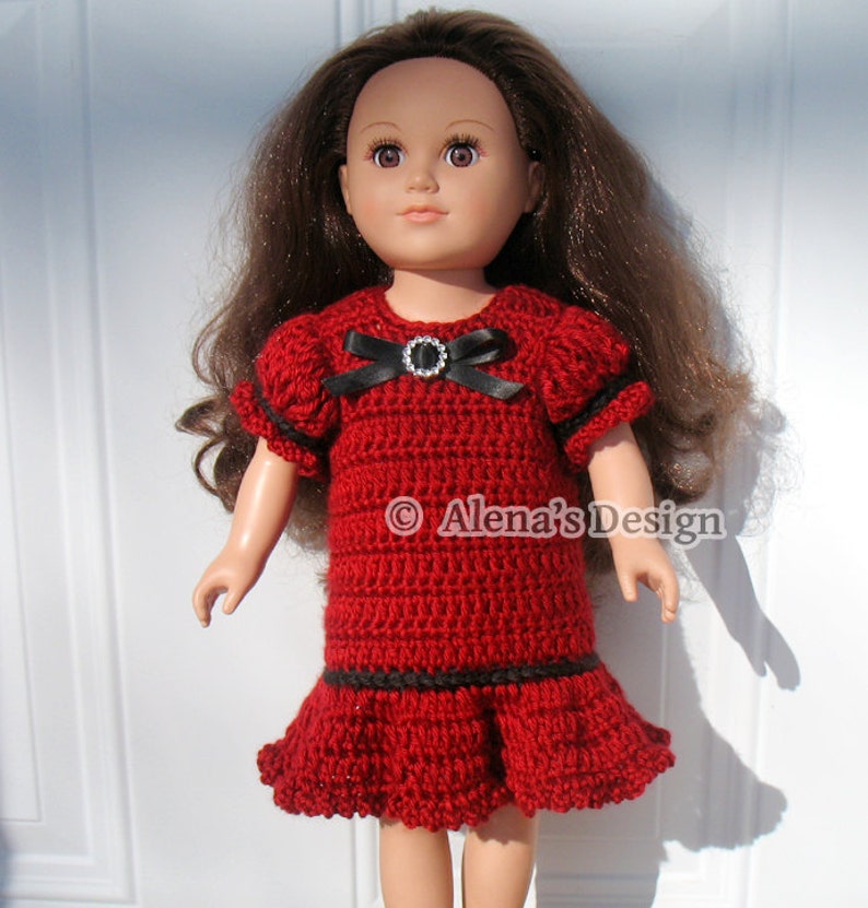May include: A red crochet dress with black trim and a black bow with a rhinestone buckle. The dress is designed for a doll.