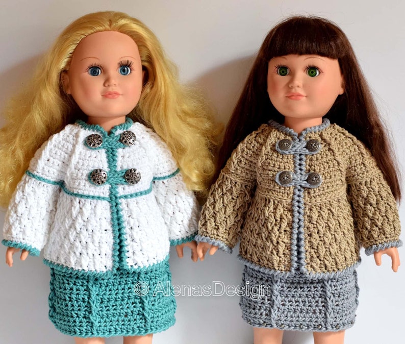 May include: Two crocheted doll outfits with matching jackets and skirts. The doll on the left is wearing a white jacket with teal trim and a teal skirt. The doll on the right is wearing a brown jacket with gray trim and a gray skirt. Both dolls have long hair and are wearing button-up jackets.