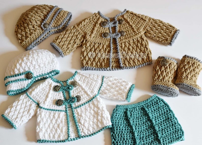 May include: A set of crocheted baby clothes in white, tan, and teal. The set includes a hat, jacket, skirt, and booties. The jacket has buttons and a teal trim. The skirt is teal and the booties are tan with a gray trim. The hat is white with a teal trim and a button.