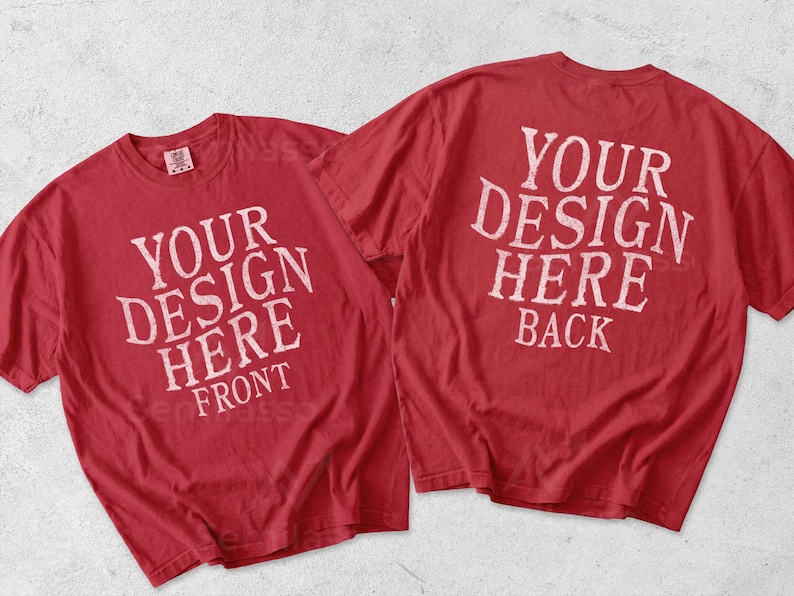 May include: Two red short-sleeve t-shirts displayed together. The left shirt features the white text 'YOUR DESIGN HERE FRONT', and the right shirt features the white text 'YOUR DESIGN HERE BACK'. Both shirts have a crew neckline and a standard fit.