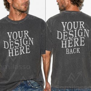 May include: Charcoal gray t-shirt with the text "YOUR DESIGN HERE" on the front and "YOUR DESIGN HERE BACK" on the back. The shirt has a vintage, distressed look. The model is wearing blue jeans.
