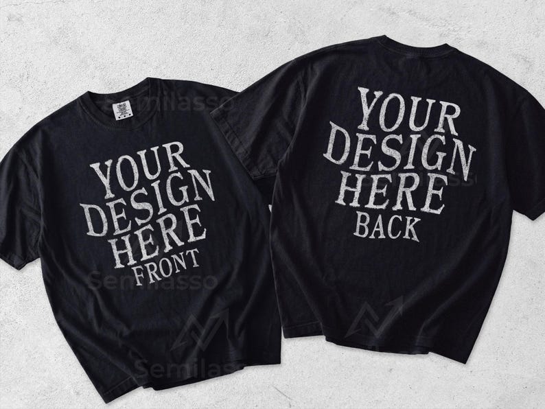 May include: Two black short-sleeve t-shirts displayed side by side. The left shirt features white text reading YOUR DESIGN HERE FRONT. The right shirt features white text reading YOUR DESIGN HERE BACK. Both shirts have a crew neckline and short sleeves.