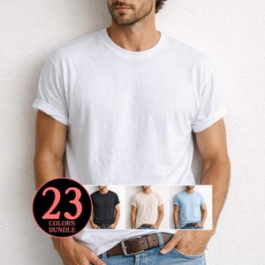以下が含まれることがあります： 袖をロールアップした無地の白い半袖クルーネックTシャツ。左下の円形グラフィックには「23 COLORS BUNDLE」というテキストが表示されており、黒、ベージュ、水色のTシャツの小さな画像が並んでいます。