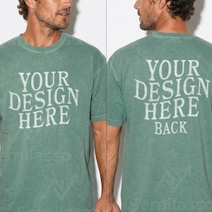 May include: A faded green t-shirt with the text "YOUR DESIGN HERE" on the front and "YOUR DESIGN HERE BACK" on the back. The shirt has a crew neck and short sleeves. The fabric appears to be a soft, worn material.