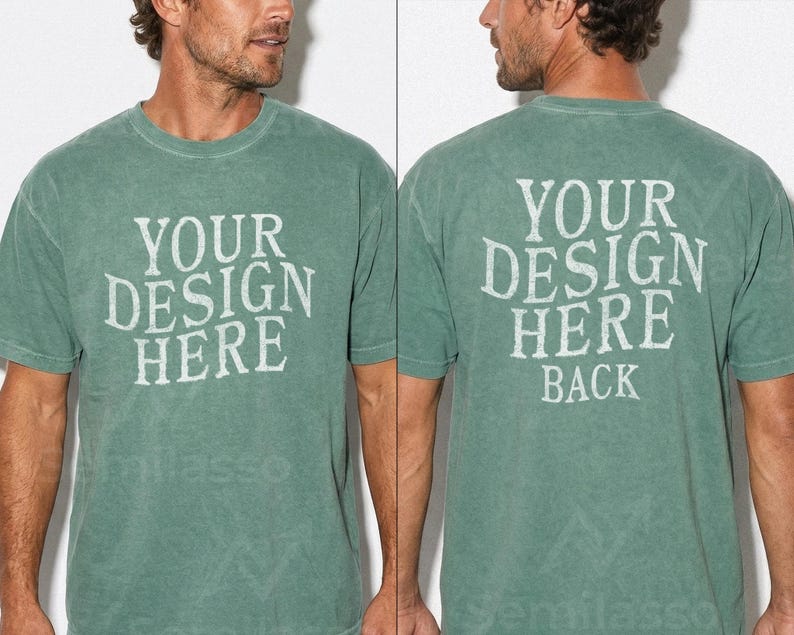 May include: A faded green t-shirt with the text "YOUR DESIGN HERE" on the front and "YOUR DESIGN HERE BACK" on the back. The shirt has a crew neck and short sleeves. The fabric appears to be a soft, worn material.
