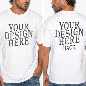 May include: White t-shirt with the text "YOUR DESIGN HERE" on the front and "YOUR DESIGN HERE BACK" on the back. The text is in a distressed, vintage-style font. The shirt is short-sleeved and appears to be made of cotton.