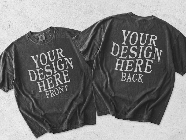 May include: Two charcoal gray short-sleeve t-shirts displayed flat. The left shirt features the white text YOUR DESIGN HERE FRONT. The right shirt features the white text YOUR DESIGN HERE BACK. Both shirts have a crew neckline and a vintage wash finish.