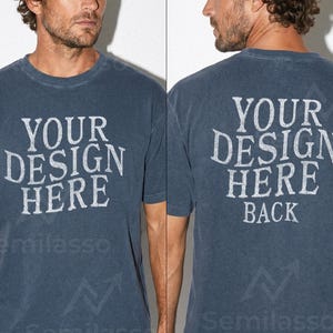 May include: A faded navy blue t-shirt with the text "YOUR DESIGN HERE" printed on the front and back. The back of the shirt also includes the word "BACK" below the main text. The shirt has short sleeves.