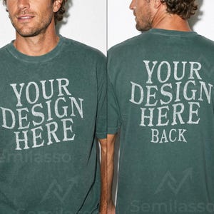 May include: A dark green t-shirt with the text "YOUR DESIGN HERE" printed on the front and back in a distressed white font. The shirt has short sleeves and a crew neck. The back of the shirt also says "BACK".