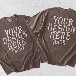 May include: Two brown short-sleeve t-shirts with a distressed texture. The left shirt features white text reading YOUR DESIGN HERE FRONT. The right shirt features white text reading YOUR DESIGN HERE BACK. Both shirts have a crew neckline.