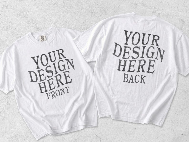 May include: Two white short-sleeve t-shirts displayed side by side. The left shirt features the black text YOUR DESIGN HERE FRONT. The right shirt features the black text YOUR DESIGN HERE BACK. Both shirts have a crew neckline and a standard fit.
