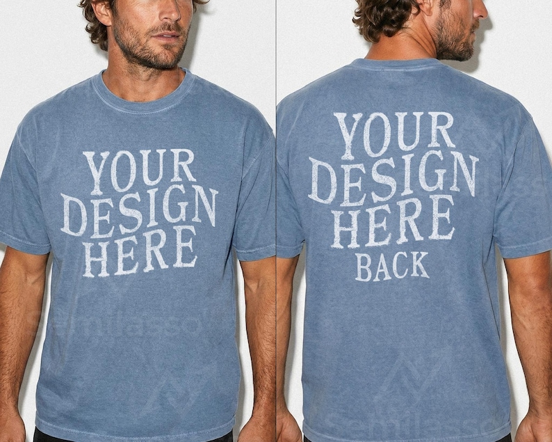 May include: A blue short-sleeved t-shirt with the text "YOUR DESIGN HERE" printed on the front and back. The back of the shirt also has the word "BACK" printed below the main text. The shirt has a vintage, faded look.