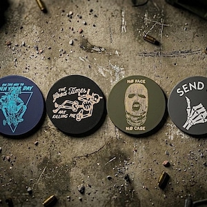 May include: Four round patches with unique designs and text. One says "ON THE WAY TO RUIN YOUR DAY" with a skeleton graphic. Another says "The Good Times ARE KILLING ME". The third says "NO FACE NO CASE". The last says "SEND IT" with a skeleton hand.