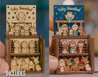 May include: Two tiered wooden nativity scene displays featuring laser cut figures of an angel, holy family, animals, and wise men. The top level shows the nativity scene with the text Feliz Navidad. The bottom level displays additional figures.