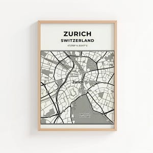 May include: A framed map print of Zurich, Switzerland. The top section features the city name and country, with coordinates below. The map is a detailed black and white street layout, including the Old Town and Lake Zurich.