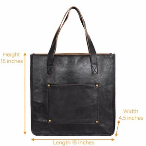 May include: Black leather tote bag with a front pocket and two handles. The bag is 15 inches in height and length, and 4.5 inches wide. The bag has brass rivets on the front pocket.