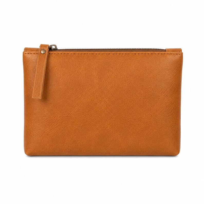 Pu&ograve; includere: Una pochette rettangolare color cuoio con una consistenza liscia simile alla pelle. La pochette presenta una chiusura a zip marrone sulla parte superiore con una linguetta abbinata fissata al cursore da un piccolo rivetto metallico.