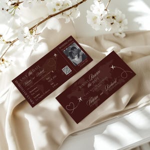 May include: Burgundy-colored boarding pass-style wedding invitations. The invitations feature the names "Victoria and Richard" and include details such as the date, time, and location. A photo of the couple is included.