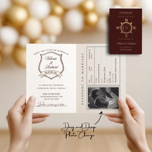 May include: A wedding invitation designed as a passport, held by hands. The invitation features the names "Victoria & Richard" and the date "14.FEB.26". A smaller passport-style card is also visible, with the same names and date. The invitation includes the text "Passport to Marriage".