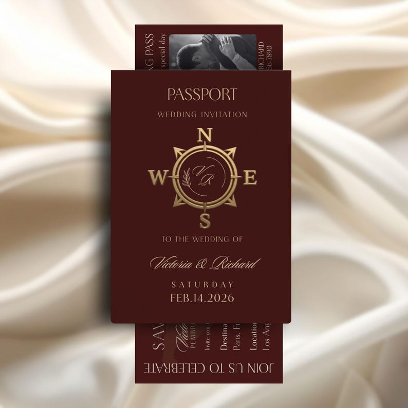 May include: A burgundy passport-style wedding invitation with gold accents. The invitation features a compass rose design and the names "Victoria & Richard" with the date "FEB.14.2026". A small photo and text are visible on the "NG PASS" card.