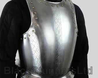 May include: A polished steel breastplate with decorative etched patterns and brass rivets along the edges. The armor is designed to protect the torso and is worn over a black garment. The text "Black Stunners Ltd" is visible.