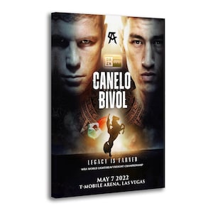 Puede incluir: Impresión en lienzo de un póster de combate de boxeo. El póster muestra los rostros de dos boxeadores, con el texto "CANELO BIVOL" en un lugar destacado. El texto adicional incluye "LEGACY IS EARNED" y detalles del evento del 7 de mayo de 2022 en el T-Mobile Arena, Las Vegas.
