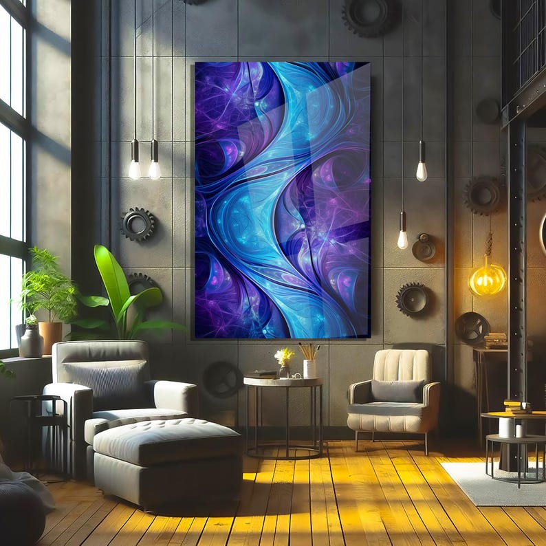 May include: Abstract art print in shades of blue and purple, displayed in a modern living room setting. The artwork features flowing, organic shapes. The room includes a grey armchair, ottoman, and wooden flooring.
