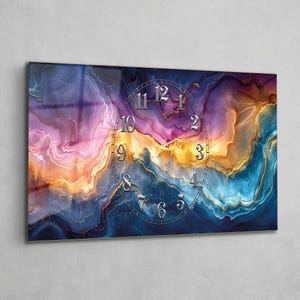 May include: A rectangular wall clock featuring a vibrant abstract fluid art design with swirling patterns of deep blue, purple, orange, and gold. The clock face displays silver metallic numerals arranged in an oval shape.