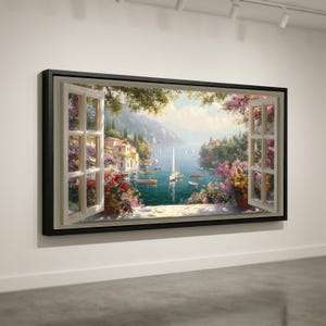 May include: A framed canvas print of a coastal scene viewed through an open window. The artwork shows a bay with boats, buildings, and greenery. The window frame is white, and the artwork is framed in black.