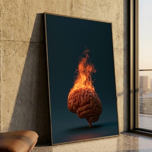 May include: A framed vertical wall art print featuring a realistic human brain centred on a dark background. The top portion of the brain is engulfed in bright orange and yellow flames that rise upwards, creating a high-contrast visual effect.