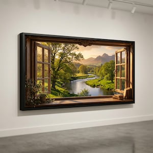 May include: A framed canvas art piece depicting a scenic landscape viewed through an open window. The window frame is brown, with a black border. The view includes a river, trees, and mountains under a sunset sky. A small plant and books are on the window sill.
