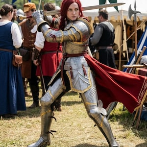 May include: A person in full plate armor, holding a sword aloft. The armor is silver with gold accents, and a red cape flows behind. The person has red hair and is in a battle stance, with other people and tents in the background.