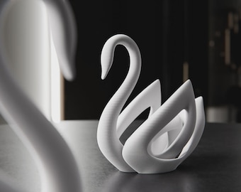 May include: A white swan sculpture with a graceful, curved neck and stylized wings. The minimalist design features smooth, flowing lines, creating a modern and elegant aesthetic. The sculpture is made of a solid, opaque material.
