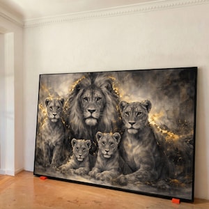 May include: A large framed canvas print depicting a lion family. The artwork uses grey, black, and gold tones. The image shows a male lion, two lionesses, and two cubs. The artwork is displayed indoors.