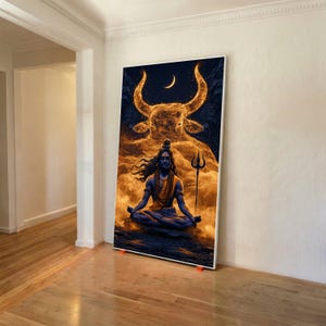 May include: A rectangular wall art print featuring a blue-toned deity sitting in a meditative pose, holding a trident. Above the figure, a large, glowing golden bull head emerges from swirling clouds beneath a crescent moon in a dark sky.