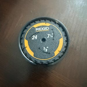 May include: A black and yellow Ridgid hole saw blade with a 7 1/4 inch diameter and a 5/8 inch arbor size. The blade has 24 teeth and is in a black container.