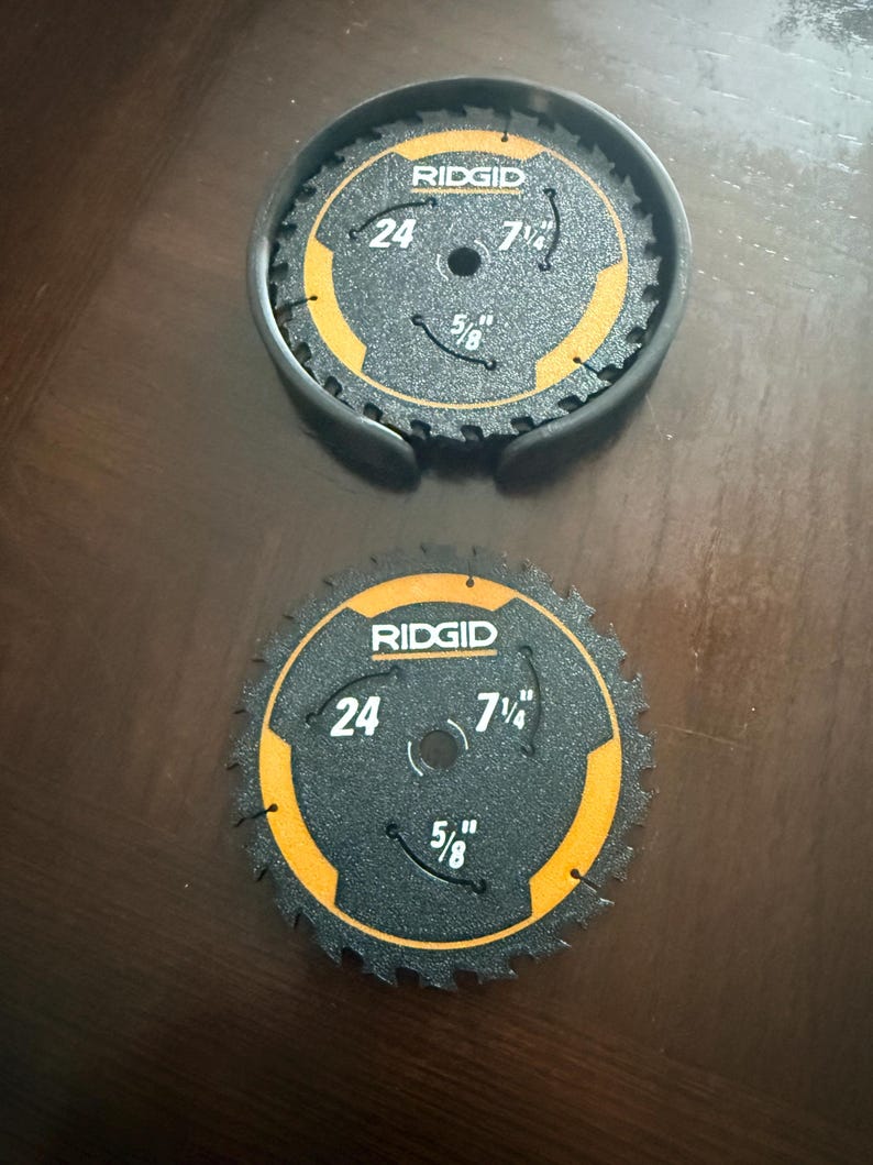 May include: Two black RIDGID circular saw blades with orange accents. Each blade has a 7 1/4 inch diameter, 5/8 inch arbor, and 24 teeth. One blade is in a black protective case.