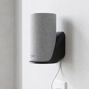 May include: A set of three ceramic mugs with a speckled, matte finish. The mugs are in shades of cream, light gray, and dark gray. Each mug has a simple, minimalist design and a rounded handle.