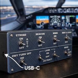 May include: A dark blue control panel with multiple toggle switches labeled "STROBE", "BEACON", "WING", "NAV & LOGO", "RWY TURN OFF", and "LAND". The panel has a USB-C port and is likely for a flight simulator.